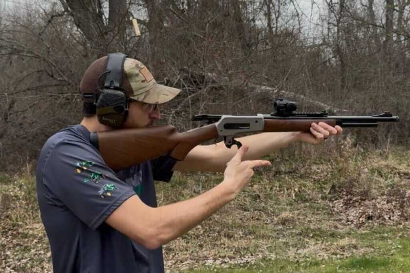 Man with hearing protection shooting lever action rifle