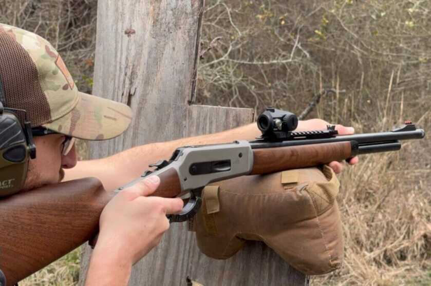 Man shooting lever action rifle