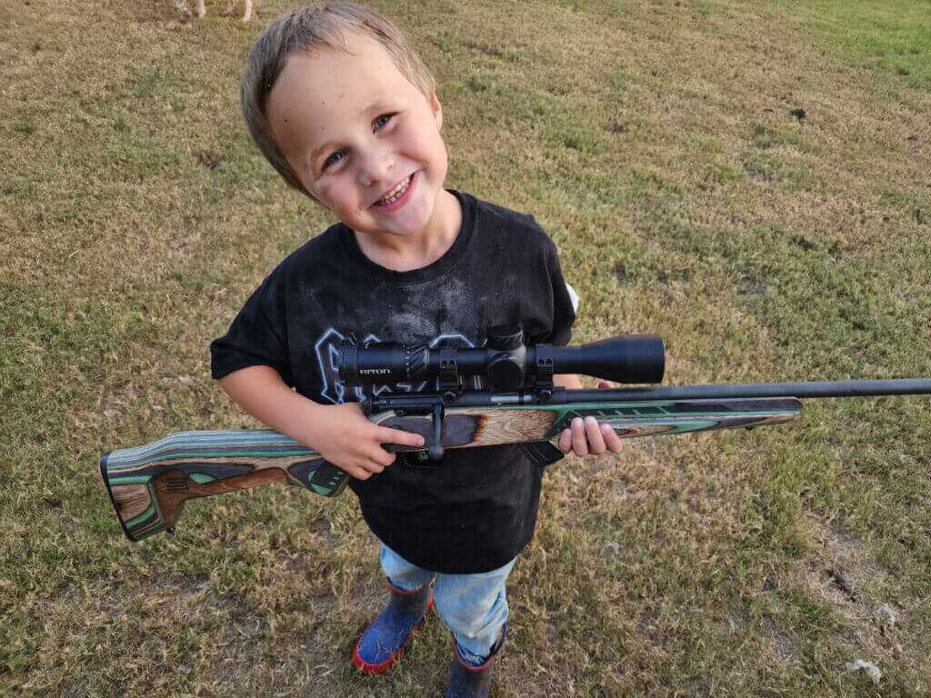 little boy with rifle