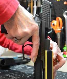 Rather than relying on hand, arm or even upper body strength, the user simply pushes the gun forward using their regular grip.  You can even use your body weight to assist.  