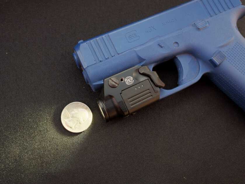 Surefire XSC micro handgun light with rechargeable proprietary battery shown on display