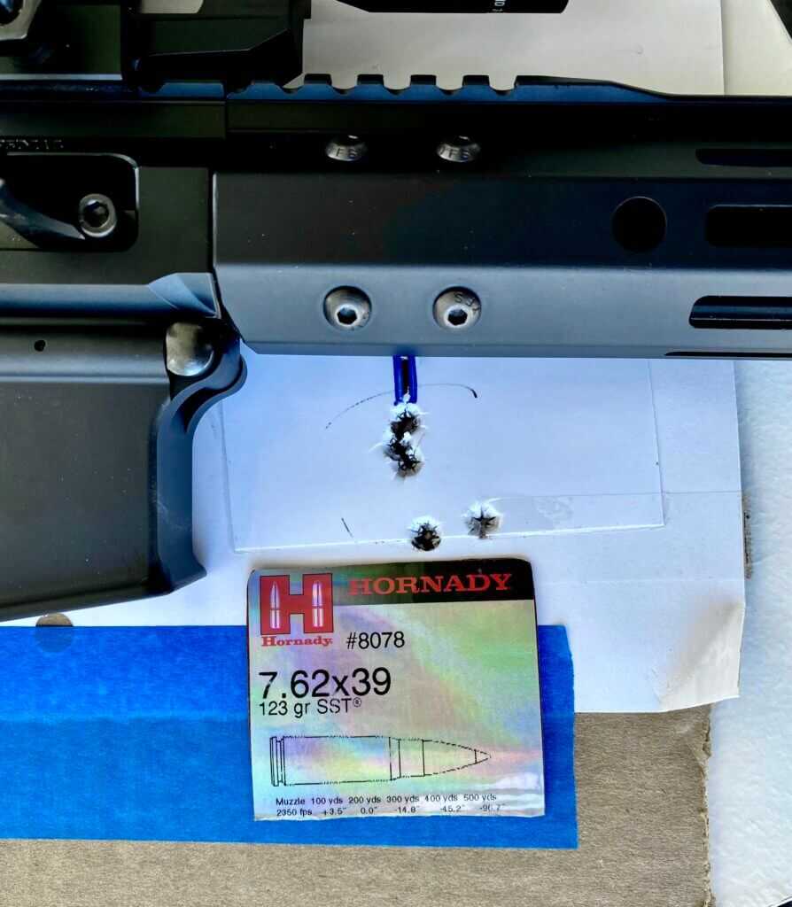 5 shot group on a target with the rifle nearby