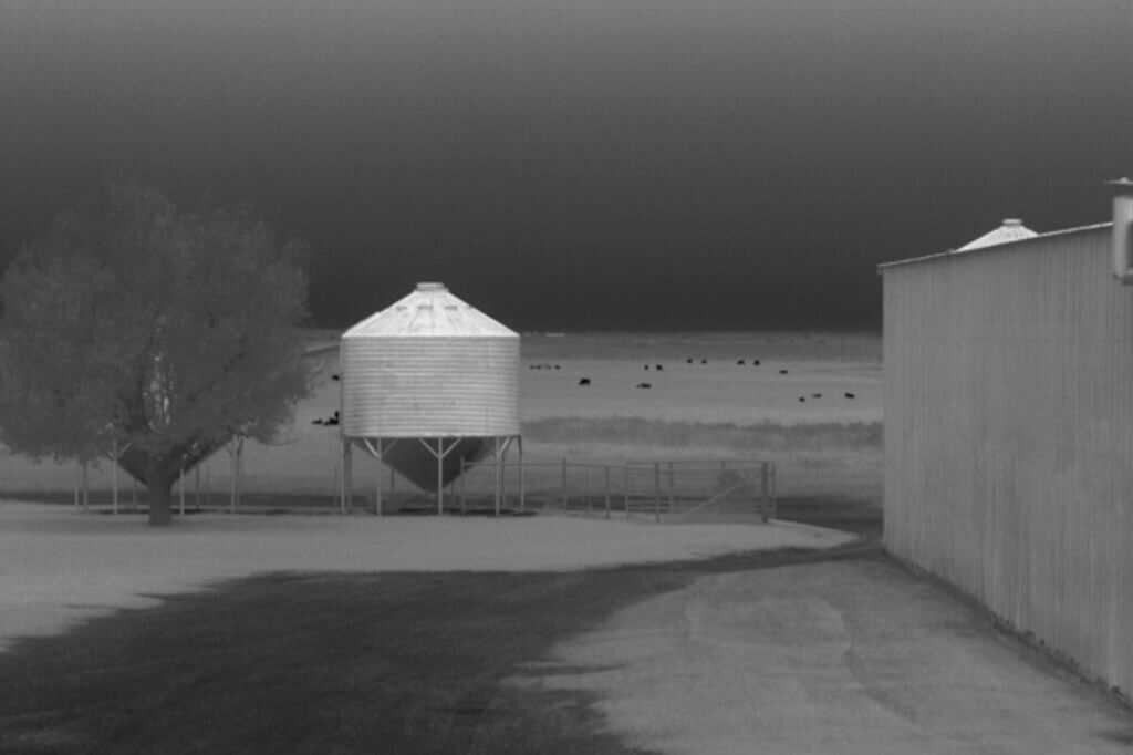 Dark 30 Defiance PTZ thermal view showing grain bin at 85 yards and cattle at 500 to 1100 yards