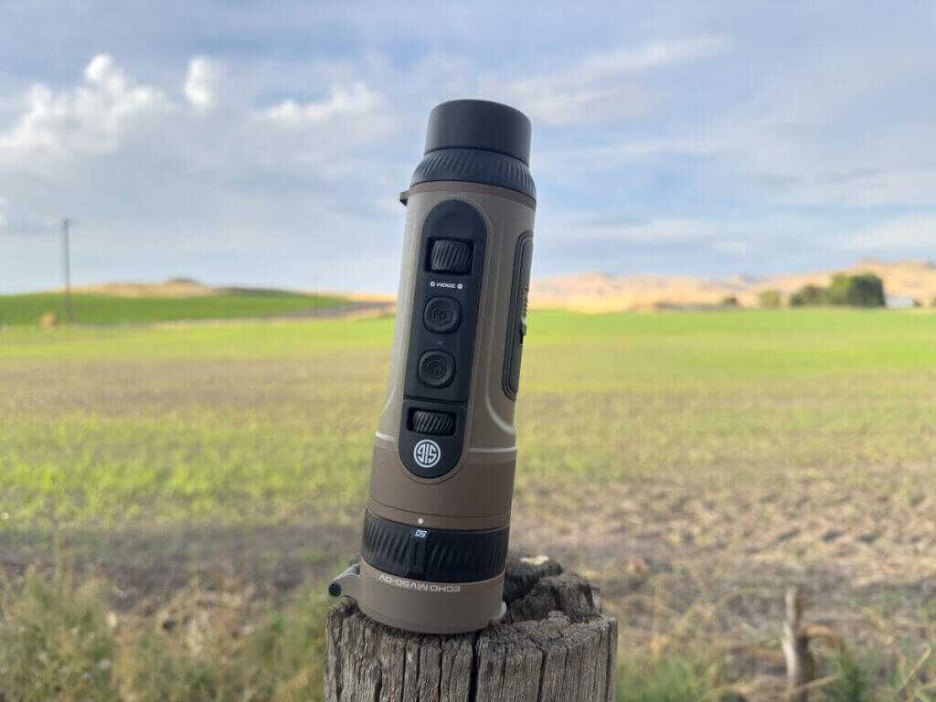 SIG Sauer Echo MV50-DV handheld thermal monocular standing upright showing one-hand control buttons in the field