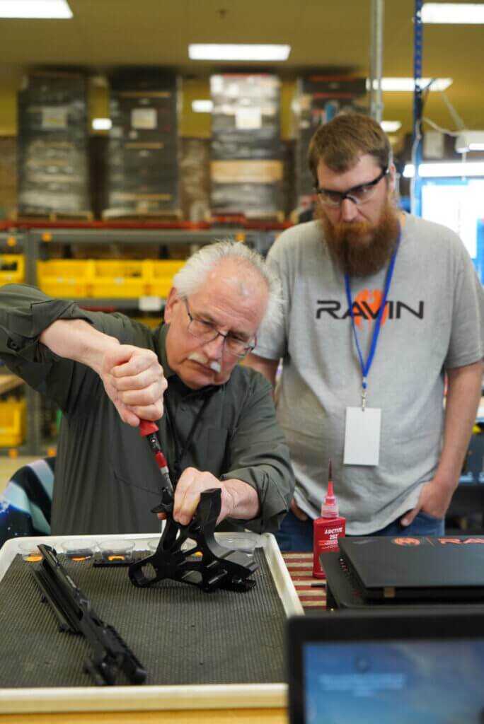 Author assembling Ravin R470 with technician guidance at factory event