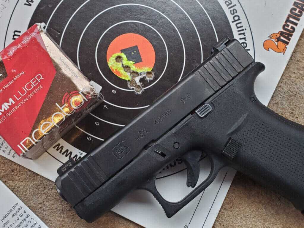 Glock pistol with factory iron sights on the range
