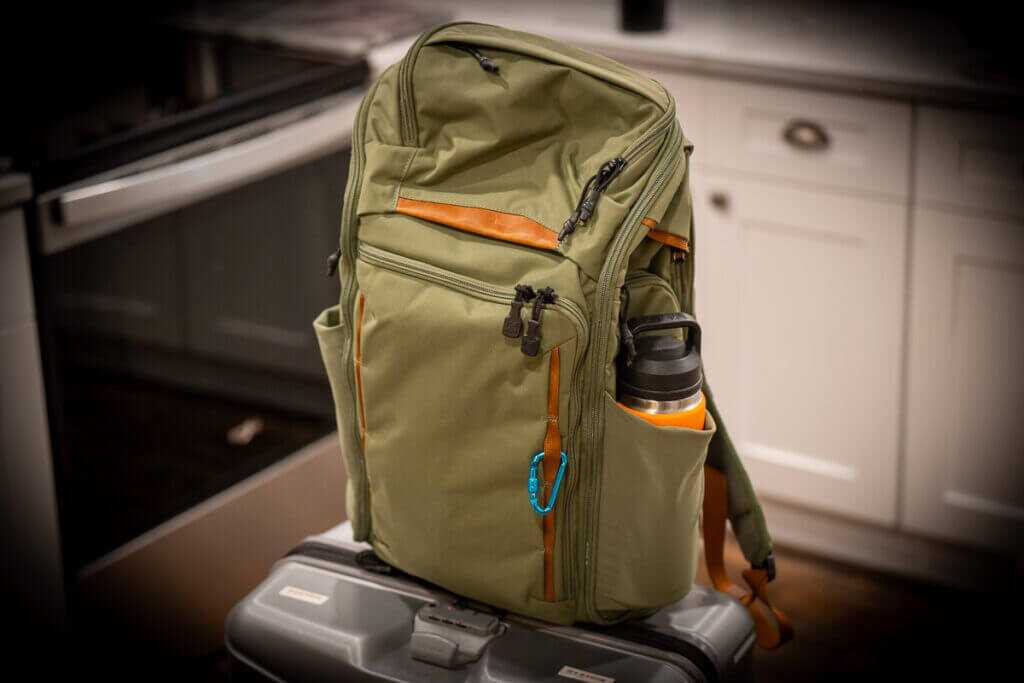 Vertx Gamut 32L backpack in Evergreen green colorway on tabletop, exterior profile