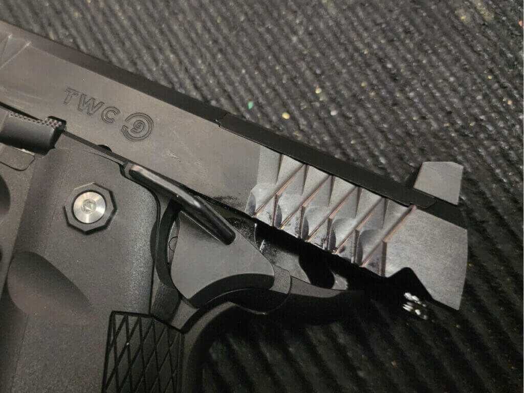 pistol with slide locked back showing robust iron sights