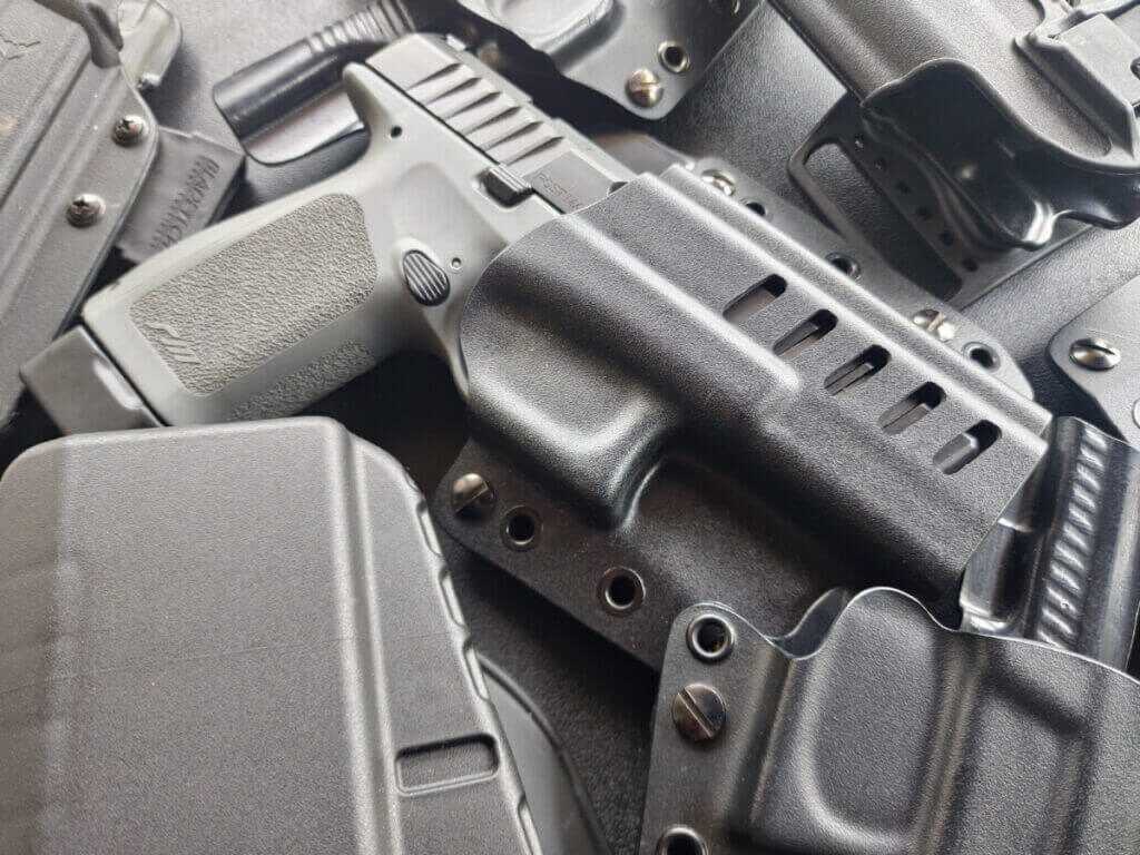 holstered handgun close view for new shooter basics