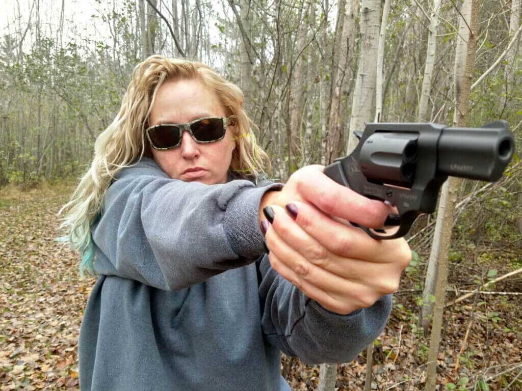 woman shooting small revolver example of snappy recoil for beginners