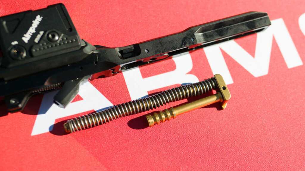 close up view of the recoil rod on a red table top.