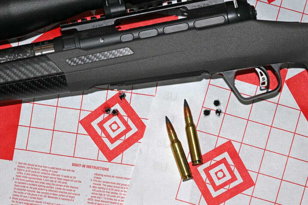 Savage 110 KLYM V2 308 Winchester accuracy testing setup with ammunition and targets