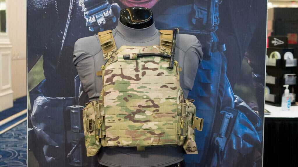 The body armor in multi cam on a mannequin.