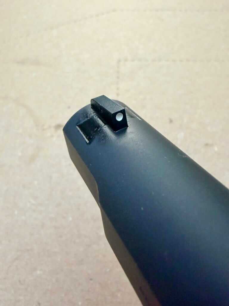 Springfield Armory SA-35 4-inch front sight detail showing the dovetailed blade and contoured base on the slide radius