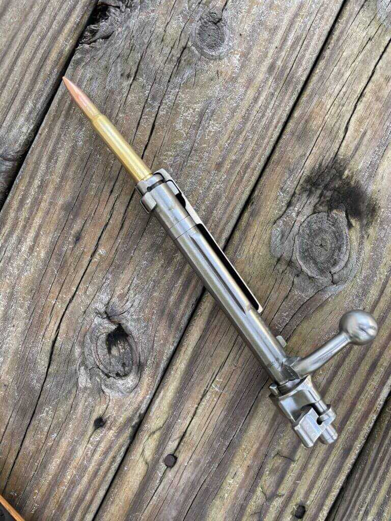 Large claw extractor on Mauser 98k bolt showing controlled feed design