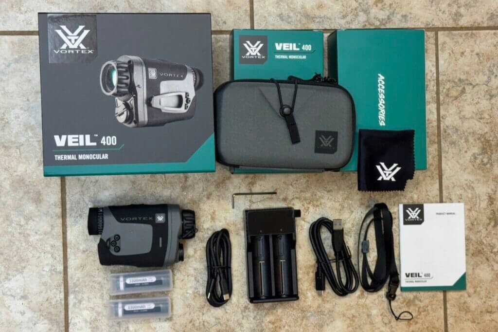 Vortex Veil 400 review accessories laid out with batteries charger cables case lanyard lens cloth and hex wrench