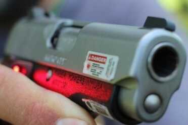 Danger! Don't look at the laser.  Also, looking down the barrel isn't recommended either. 