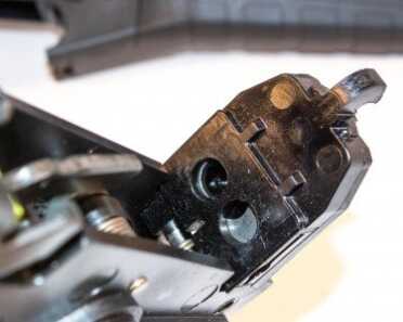 The two holes shield the crossbar which activates one extractor while stopping the other.