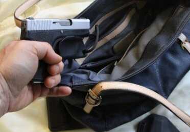 When you draw the gun it comes off. 