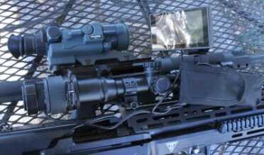 The top one (green) is my rock solid Yukon Gen I nightvision riflescope, currently $389 on Amazon. The bottom one is the Digital Crosshairs contraption.