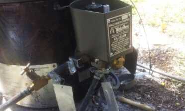 This is the assembled regulator. The bottom goes to the bottom of the burner inside the stove. The left one is the fuel line in and the right is the overflow line. 