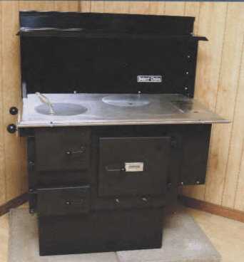 This "Bakers Choice" stove is linked in the article from Lehmans and another supplier for about the same $1800, before freight shipping costs from Ohio. It has a stainless steel top and a water tank, and it was the lowest cost option I found prior to this stove. 