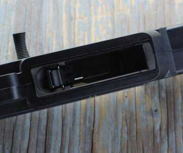 The mag-well is easy to find, and has a thumb latch for the release.