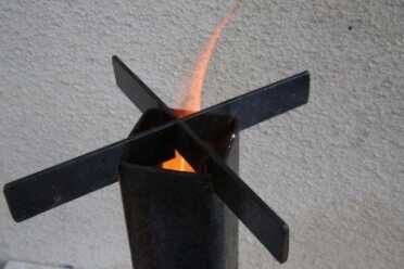 Don't be shy about putting sticks and leaves down the top once you get the fire going and they won't choke it. A raging fire will get you up to temp quick.