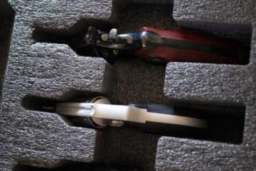 A snub-nosed Smith next to a 6" Python with the barrels down in the foam.