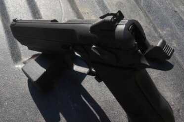 The top of the slide is ribbed, and the sights are ramped--easy to holster.