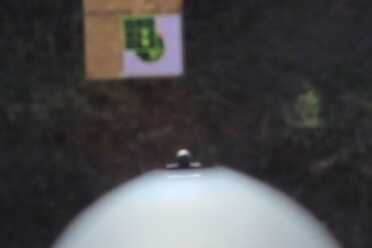 The brass bead catches available light.