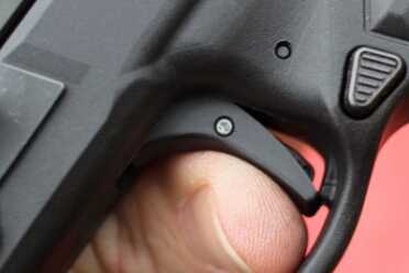 There's a plateau behind the trigger that stops over-travel. 