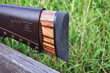 The laminated stock of the rifle is topped off with a generous recoil pad. Note the Galco "Butt Cuff."
