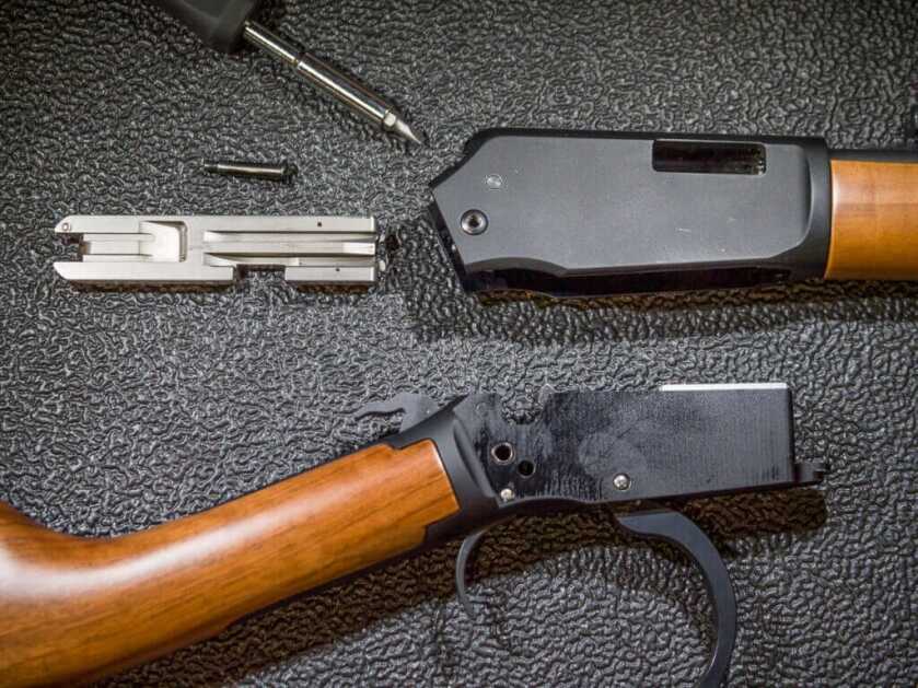 Close up of the action and all its interior pieces layed out on the table.