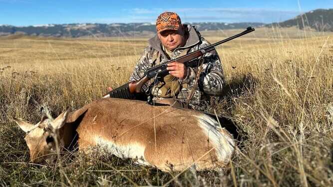 hunter with old school Winchester .71 rifle and pronghorn