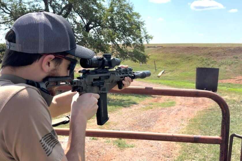 Man aiming a rifle with the Arken EP-8 scope