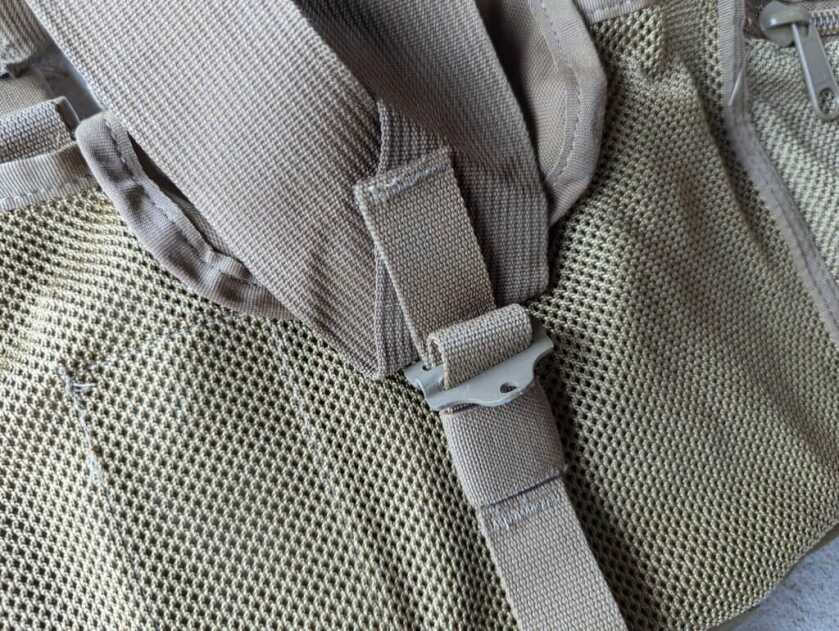 Rear metal buckle on chest rig.