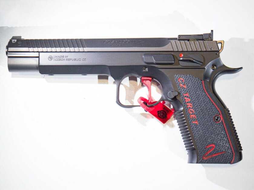 The CZ Shadow 2 Target laying on a white table facing to the left with its left side visible.