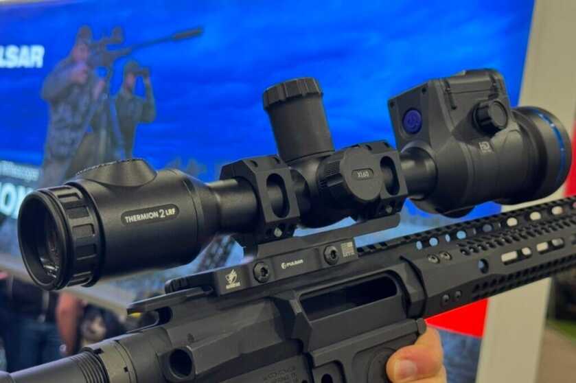 Pulsar Thermion 2 LRF XL60 thermal scope handled on the SHOT Show 2025 floor, showing large objective and integrated rangefinder.