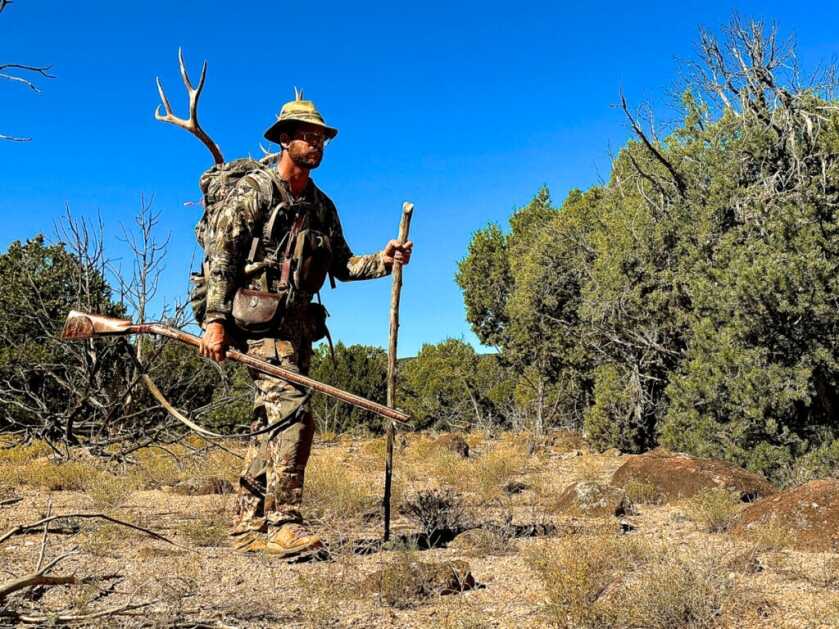 Backcountry pack out after mule deer harvest with traditional flintlock rifle in Utah high desert terrain