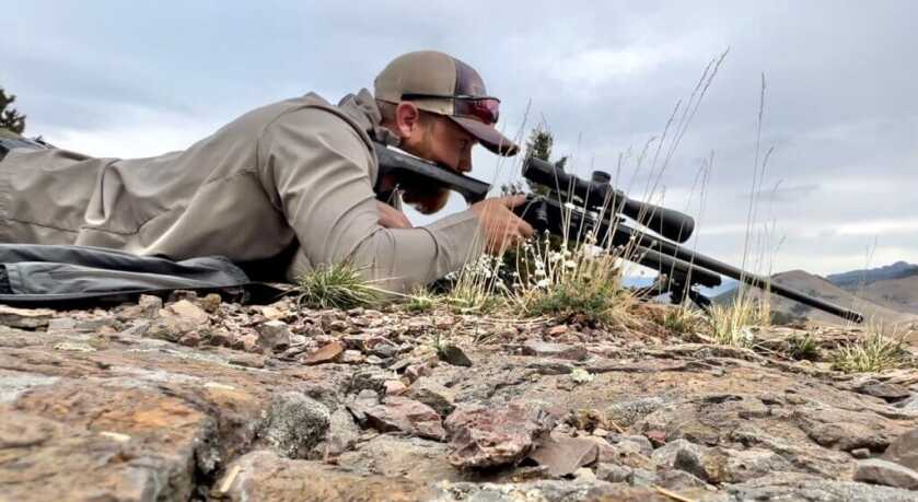 3 - Fireside Stories: How I Killed My Smallest Bull Elk on The Best Tag I've Ever Had - Part 1 of 3 A hunter lays prone behind his long range rifle in preparation for his shot.