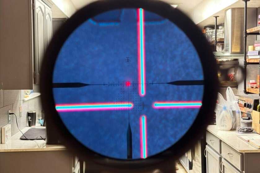 image through the scope of a rifle with a clip-on thermal at the end