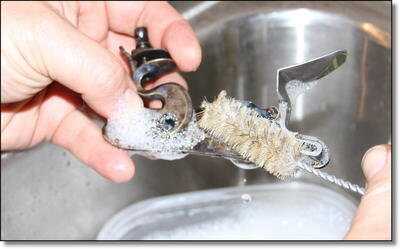 Make sure you remove the two side screws and remove the entire lock assembly for cleaning. I don't disassemble it further than this and I scrub it with soapy water and a toothbrush or other soft bristle brush, using dish soap