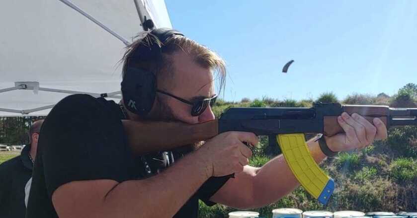 man with firearm wearing eye and ear protection Safety