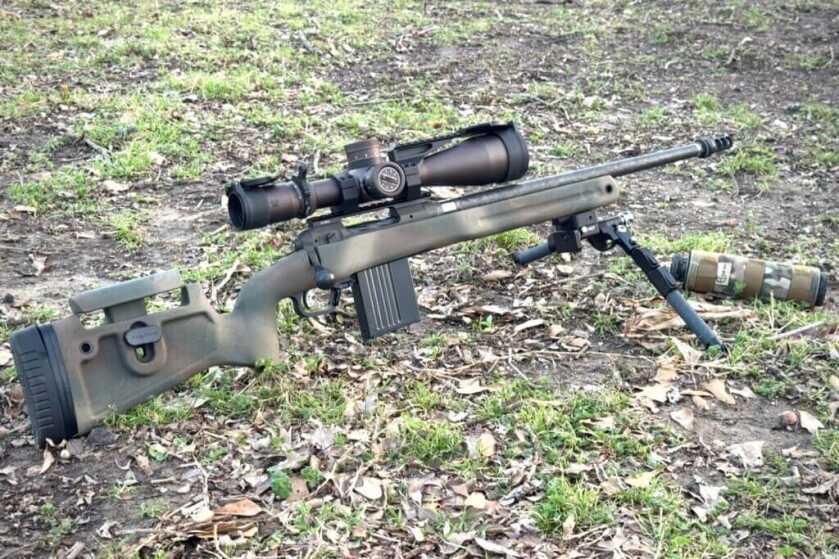 Camo Savage 110 PPR with scope and bipod set in grass