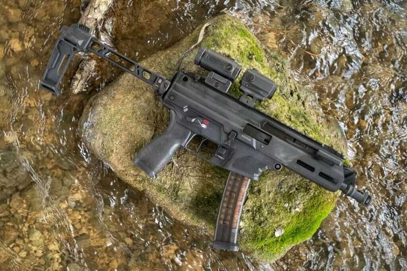 Cool gun on mossy rock in flowing creek