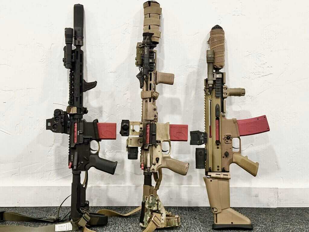 Three different firearms are posed, all with the same dryfire training device installed.