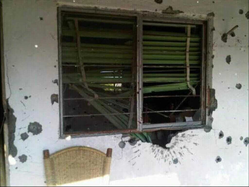 home of Alejo Garza Tamez with visible bullet holes and shrapnel pattern