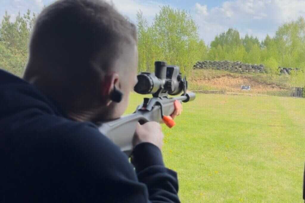 man shooting a rifle with a thermal scope
