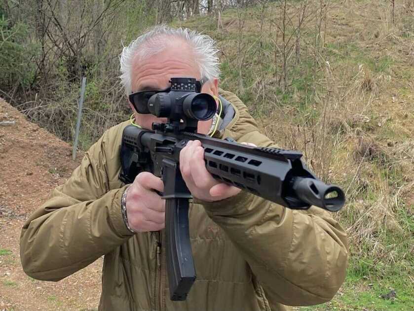 man hold the BCA ar-15 complete 7.62x39 and looking through the scope